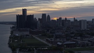 DX0002_197_042 - 5.7K aerial stock footage the riverfront GM Renaissance Center and skyline at sunset, Downtown Detroit, Michigan