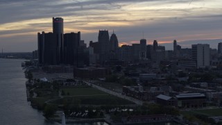 DX0002_197_043 - 5.7K aerial stock footage the riverfront GM Renaissance Center and skyscrapers at sunset, Downtown Detroit, Michigan
