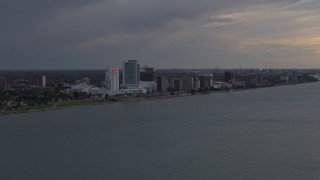DX0002_197_045 - 5.7K aerial stock footage of the city's skyline on the other side of the river at sunset, Windsor, Ontario, Canada