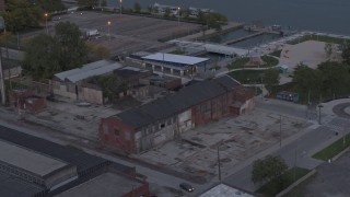 DX0002_197_053 - 5.7K aerial stock footage of circling above an abandoned brick building at sunset, Detroit, Michigan