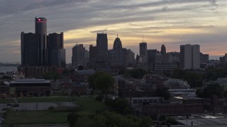 DX0002_197_054 - 5.7K aerial stock footage of focusing on the city's tall skyscrapers during descent at sunset, Downtown Detroit, Michigan