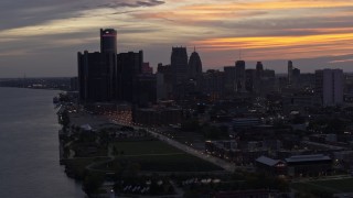 DX0002_198_006 - 5.7K aerial stock footage the city's towering skyscrapers at sunset seen from the river, Downtown Detroit, Michigan
