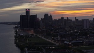 DX0002_198_007 - 5.7K aerial stock footage the city's towering skyscrapers at sunset seen from the Detroit River, Downtown Detroit, Michigan