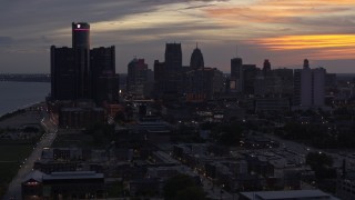 DX0002_198_008 - 5.7K aerial stock footage the city's towering skyscrapers at sunset seen during descent, Downtown Detroit, Michigan