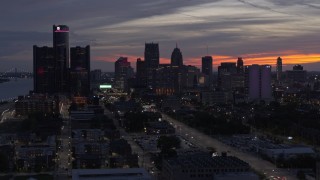 DX0002_198_010 - 5.7K aerial stock footage of ascending past the city's towering skyscrapers at twilight, Downtown Detroit, Michigan