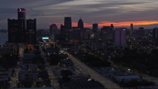 DX0002_198_013 - 5.7K aerial stock footage of slowly passing the city's towering skyscrapers at twilight, Downtown Detroit, Michigan