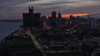 DX0002_198_014 - 5.7K aerial stock footage of flying past the city's tall skyscrapers at twilight, Downtown Detroit, Michigan