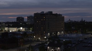 DX0002_198_023 - 5.7K aerial stock footage of circling an apartment building at twilight, Detroit, Michigan