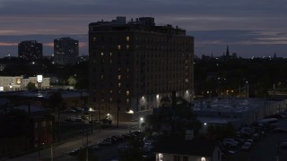 DX0002_198_024 - 5.7K aerial stock footage descend and circle an apartment building at twilight, Detroit, Michigan