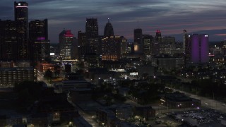 DX0002_198_026 - 5.7K aerial stock footage of flying by and away from the city's skyline at twilight in Downtown Detroit, Michigan