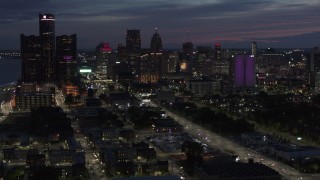 DX0002_198_027 - 5.7K aerial stock footage of ascending away from the city's skyline at twilight in Downtown Detroit, Michigan