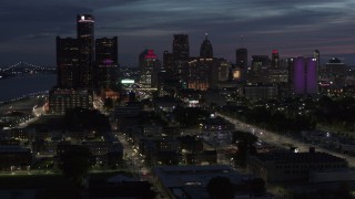 DX0002_198_028 - 5.7K aerial stock footage of the city's skyline, seen from Jefferson Ave, at twilight in Downtown Detroit, Michigan
