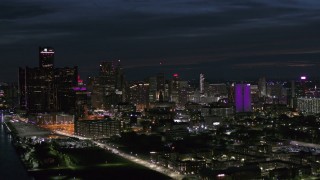 DX0002_198_035 - 5.7K aerial stock footage flyby the brightly lit city skyline at night, Downtown Detroit, Michigan