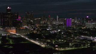 DX0002_198_036 - 5.7K aerial stock footage of a view of the brightly lit city skyline at night, Downtown Detroit, Michigan