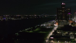 DX0002_198_046 - 5.7K aerial stock footage pan from the Downtown Detroit, Michigan skyline to reveal Windsor, Canada across the Detroit River