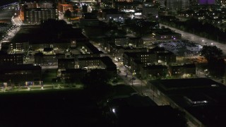 DX0002_198_051 - 5.7K aerial stock footage of orbiting an apartment complex at night, Downtown Detroit, Michigan