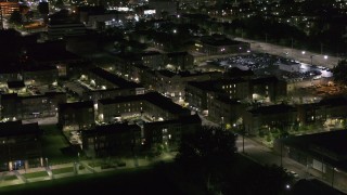 DX0002_198_053 - 5.7K aerial stock footage descend toward an apartment complex at night, Downtown Detroit, Michigan