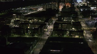 DX0002_198_055 - 5.7K aerial stock footage of Franklin Street and an apartment complex at night, Downtown Detroit, Michigan