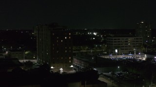 DX0002_198_057 - 5.7K aerial stock footage descend and orbit an apartment building at night, Detroit, Michigan