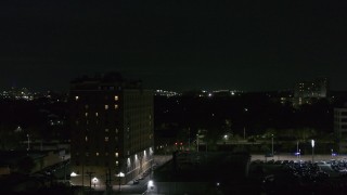 DX0002_198_060 - 5.7K aerial stock footage orbit an apartment building at nighttime, Detroit, Michigan