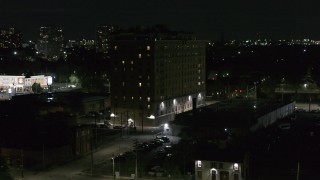 DX0002_198_062 - 5.7K aerial stock footage descend while focused on Pasadena Apartments at nighttime, Detroit, Michigan