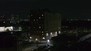DX0002_198_063 - 5.7K aerial stock footage approaching Pasadena Apartments at nighttime, Detroit, Michigan