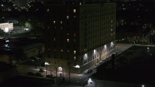 DX0002_198_064 - 5.7K aerial stock footage of a reverse view of Pasadena Apartments at nighttime, Detroit, Michigan