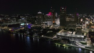 DX0002_199_005 - 5.7K aerial stock footage stationary view of towering skyscrapers and Hart Plaza at night, Downtown Detroit, Michigan