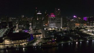 DX0002_199_007 - 5.7K aerial stock footage of orbiting towering skyscrapers and Hart Plaza at night, Downtown Detroit, Michigan