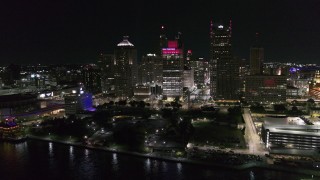 DX0002_199_008 - 5.7K aerial stock footage orbit towering skyscrapers and Hart Plaza at night, Downtown Detroit, Michigan