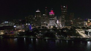 DX0002_199_010 - 5.7K aerial stock footage orbit Hart Plaza and towering skyscrapers at night, Downtown Detroit, Michigan