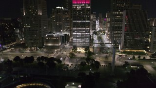 DX0002_199_015 - 5.7K aerial stock footage Jefferson Avenue seen while descending to Hart Plaza at night, Downtown Detroit, Michigan