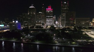 DX0002_199_023 - 5.7K aerial stock footage orbit Hart Plaza, focus on tall skyscrapers at night, Downtown Detroit, Michigan