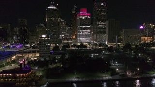 DX0002_199_024 - 5.7K aerial stock footage orbit riverfront Hart Plaza, focus on tall skyscrapers at night, Downtown Detroit, Michigan