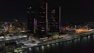 DX0002_199_027 - 5.7K aerial stock footage of orbiting GM Renaissance Center by the river at night, Downtown Detroit, Michigan