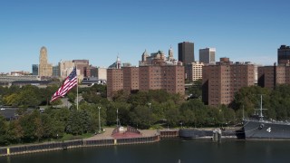 DX0002_200_001 - 5.7K aerial stock footage flying away from Downtown Buffalo and apartment complex, reveal warship, New York