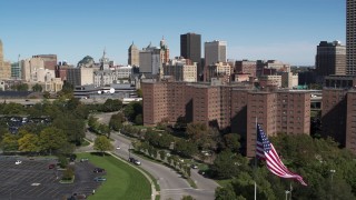 DX0002_200_006 - 5.7K aerial stock footage descend by apartment buildings with view of skyline, Downtown Buffalo, New York