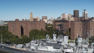 DX0002_200_015 - 5.7K aerial stock footage ascend past apartment buildings and warship to focus on skyline, Downtown Buffalo, New York