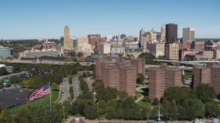 DX0002_200_016 - 5.7K aerial stock footage focus on skyline and descend past apartment buildings, Downtown Buffalo, New York