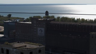 DX0002_201_036 - 5.7K aerial stock footage of a water tower on a flour mill in Buffalo, New York