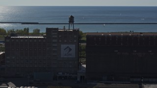 DX0002_201_038 - 5.7K aerial stock footage of circling a water tower on a flour mill in Buffalo, New York