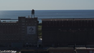 DX0002_201_039 - 5.7K aerial stock footage view of a water tower on a flour mill in Buffalo, New York