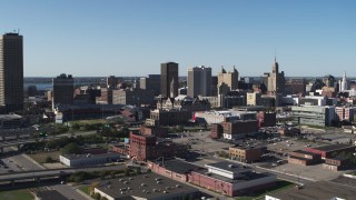 DX0002_202_013 - 5.7K aerial stock footage ascend away from Erie Community College, baseball stadium, office towers in Downtown Buffalo, New York