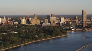 DX0002_203_040 - 5.7K aerial stock footage of the downtown skyline seen from the lakeside park at sunset, Downtown Buffalo, New York