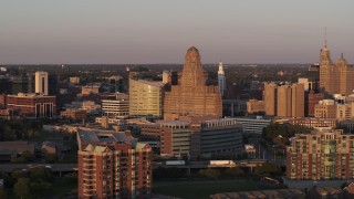 DX0002_204_005 - 5.7K aerial stock footage of a view of city hall at sunset, Downtown Buffalo, New York