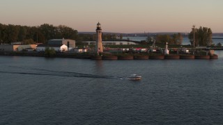 DX0002_204_017 - 5.7K aerial stock footage approach Lake Erie lighthouse at sunset, Buffalo, New York