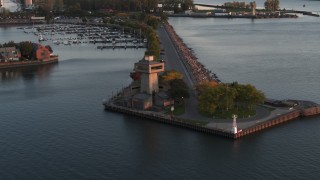 DX0002_204_021 - 5.7K aerial stock footage ascend away from a lakeside observation deck at sunset, Buffalo, New York
