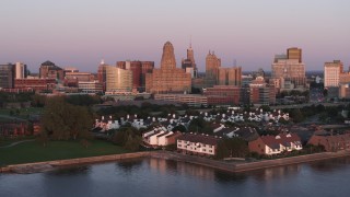DX0002_204_025 - 5.7K aerial stock footage a view of city hall and office buildings at sunset, seen from waterfront condos, Downtown Buffalo, New York