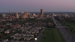 DX0002_204_032 - 5.7K aerial stock footage wide view of Seneca One Tower and the city's skyline seen from I-190 at twilight, Downtown Buffalo, New York