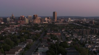 DX0002_204_034 - 5.7K aerial stock footage wide view of Seneca One Tower and the city's skyline seen from homes at twilight, Downtown Buffalo, New York
